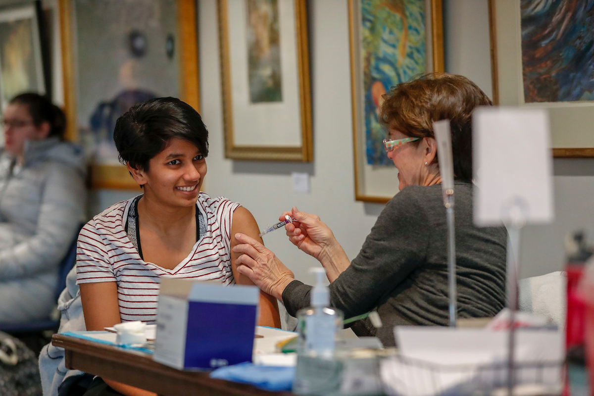 Student getting a vaccine at a flu shot clinic